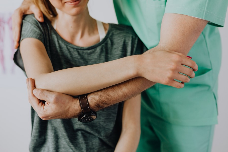 Physiotherapist mobilising a patient’s shoulder